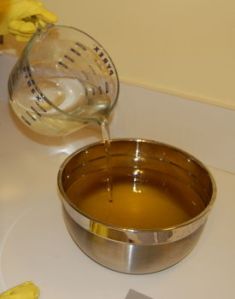 Pouring lye into oils for soap making