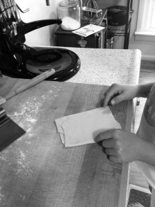 Folding pasta dough to roll it black and white photograph on andreabadgley.com