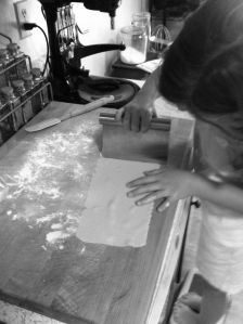 Cutting pasta dough into manageable sheets b&w photo on andreabadgley.com