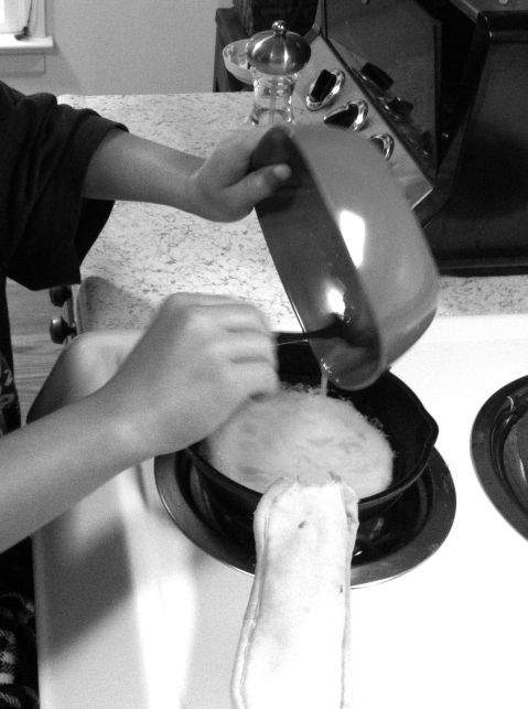 Daughter (7) scrambling an egg black and white photo on andreabadgley.com