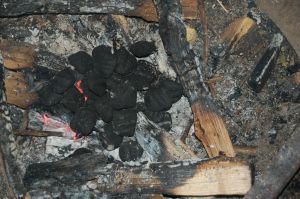 Pile of charcoal briquettes on campfire for Dutch oven crisp on andreabadgley.com
