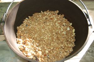 Assembled blueberry crisp in cast iron Dutch oven for campfire dessert on andreabadgley.com
