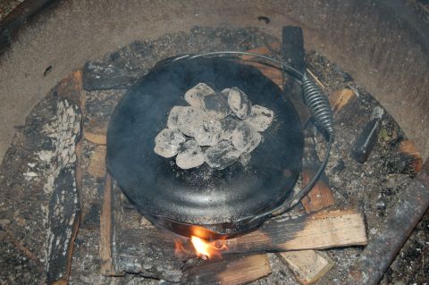 Cast iron Dutch oven with campfire coals on andreabadgley.com
