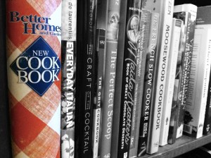 Red and white checked cookbook on shelf black and white selectively colorized photograph on andreabadgley.com