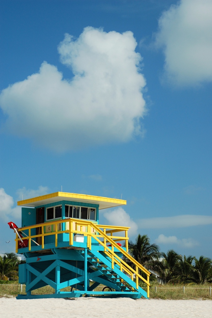 Blue and yellow lifeguard stand with clouds by Andrea Badgley on Butterfly Mind