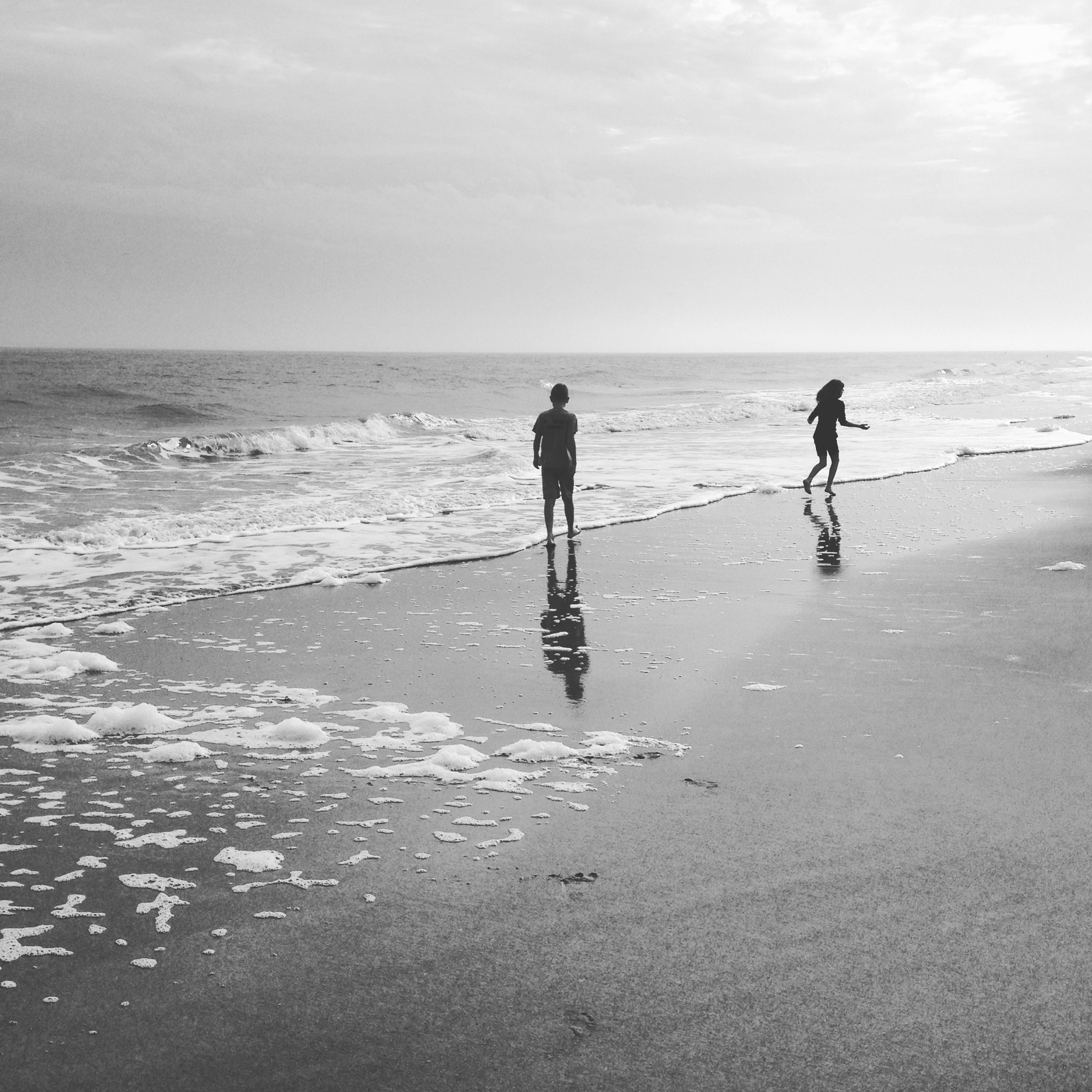 Black and white photo of kids at beach